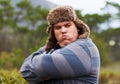 Angry, frustrated and young overweight man in nature during winter unhappy, grumpy and sad due to outdoor problem. Anger Royalty Free Stock Photo