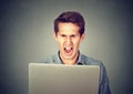 Angry furious business man screaming at computer Royalty Free Stock Photo