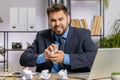 Angry furious man working at home office throwing crumpled paper, having nervous breakdown at work Royalty Free Stock Photo