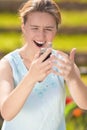 Angry and Furious Young Caucasian Woman With Cellphone on Hands Royalty Free Stock Photo