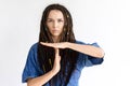Angry girl with dreadlocks shows time out sign with hands Royalty Free Stock Photo