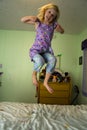 Angry girl jumping on a bed