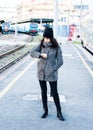 Angry girl waiting for her train to arrive at the railway station Royalty Free Stock Photo