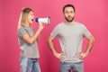 angry girlfriend shouting with megaphone at boyfriend, isolated