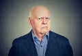 Angry, grumpy senior business man, isolated on gray background