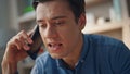 Angry guy shouting mobile phone closeup. Mad man calling cell at business place Royalty Free Stock Photo