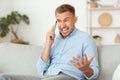 Angry guy talking on mobile phone and shouting Royalty Free Stock Photo