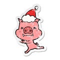 angry hand drawn distressed sticker cartoon of a pig wearing santa hat