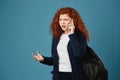 Angry handsome student girl looking aside, expressive gesticulating with hands, arguing with mother about study on phone