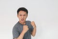 Angry and hate face of young Asian man in gray t-shirt with angry hand gesture Royalty Free Stock Photo