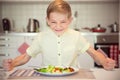 Angry hungry boy banging his fist on the table Royalty Free Stock Photo