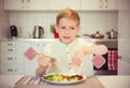 Angry hungry boy child complains about the food Royalty Free Stock Photo