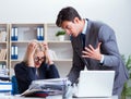 Angry irate boss yelling and shouting at his secretary employee Royalty Free Stock Photo