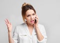 Angry irritated woman talking on mobile phone Royalty Free Stock Photo