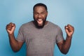 Angry irritated young african man screaming looking camera isolated on blue color background Royalty Free Stock Photo