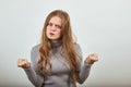 An angry irritated young woman with red hair is nervous looking at the camera Royalty Free Stock Photo