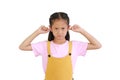Angry kid close plug ears scream loudly tired by noisy sound, furious angry. Annoyed Asian little girl isolated on white