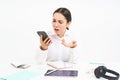 Angry lady boss, businesswoman looks frustrated, talks on mobile phone, has an argument during conversation on cellphone Royalty Free Stock Photo