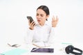 Angry lady boss, businesswoman looks frustrated, talks on mobile phone, has an argument during conversation on cellphone Royalty Free Stock Photo