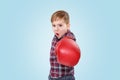 Angry little boy with red boxing gloves punching at camera Royalty Free Stock Photo