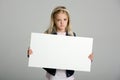 Angry little girl holding a blank sign Royalty Free Stock Photo