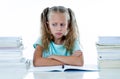 Angry little girl with a negative attitude towards studies and school after studying too much and having too many homework in Royalty Free Stock Photo