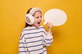 Angry little girl screaming with speech bubble icon with blank text inside informing about school task with empty space for idea