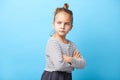 Angry little girl standing over white background, crossed her hands, sign and gesture concept. Royalty Free Stock Photo