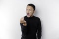 The angry and mad face of Asian man in black shirt isolated white background Royalty Free Stock Photo