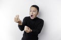 The angry and mad face of Asian man in black shirt isolated white background Royalty Free Stock Photo