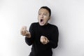 The angry and mad face of Asian man in black shirt isolated white background Royalty Free Stock Photo