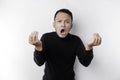 The angry and mad face of Asian man in black shirt isolated white background Royalty Free Stock Photo