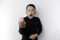 The angry and mad face of Asian man in black shirt isolated white background Royalty Free Stock Photo