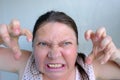 Angry mad middle aged woman looks angrily, squints her eyes, face close up, emotional explosion from stress, female life, anger Royalty Free Stock Photo