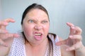 Angry mad middle aged woman looks angrily, squints her eyes, face close up, emotional explosion from stress, female life, anger Royalty Free Stock Photo