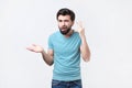 Angry mad young hispanic man gesturing with his finger against temple asking are you crazy. Royalty Free Stock Photo