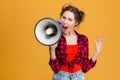 Angry mad young woman screaming in megaphone Royalty Free Stock Photo