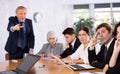 Angry male boss reprehending colleagues on meeting in office Royalty Free Stock Photo