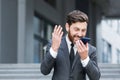 Angry male businessman cry talking on the phone outside business man shouting on call outdoors. Nervous mad professional Royalty Free Stock Photo