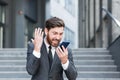 Angry male businessman cry talking on the phone outside business man shouting on call outdoors. Nervous mad professional Royalty Free Stock Photo