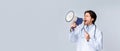 Angry male doctor shouting with megaphone at copy space on light background Royalty Free Stock Photo