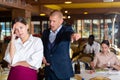 Angry man client of restaurant yelling at young waitress Royalty Free Stock Photo