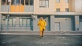 Angry man courier in yellow clothes throwing pizza boxes on the floor