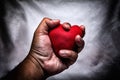 angry man crushing red heart in hand., unrequited love., love co Royalty Free Stock Photo