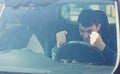 Angry man driver hitting the steering wheel with his fists. Irritated and furious man grinding teeth Royalty Free Stock Photo