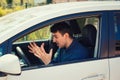 Angry man driving a vehicle arguing and gesturing shaking his hands perplexed Royalty Free Stock Photo
