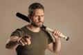 angry man express anger with bat pointing finger isolated on grey background. Royalty Free Stock Photo