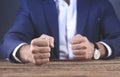 Angry man fists on wooden table background Royalty Free Stock Photo