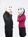 Angry man and a happy woman with a plate in the face