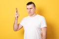 Angry man holding a smartphone. Aggressive man talking on the phone Royalty Free Stock Photo
